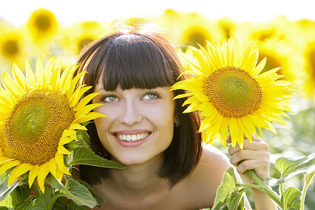 istock Young pretty woman on a sunflowers background 89360113