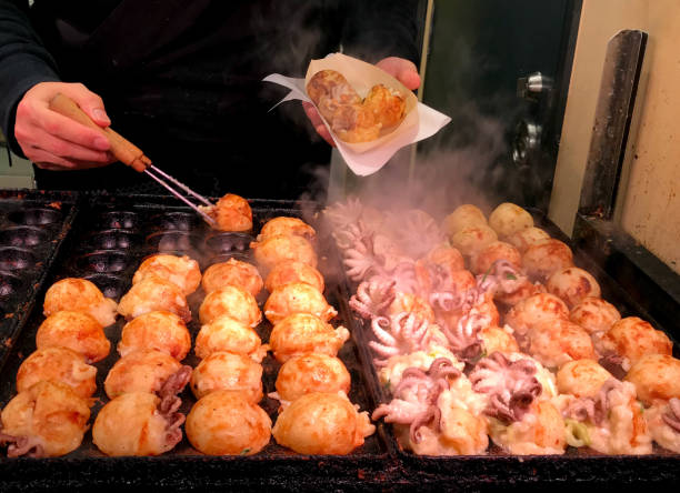 Japanese snack street food, takoyaki in hot pan Japanese famous street food, takoyaki in hot pan takoyaki stock pictures, royalty-free photos & images