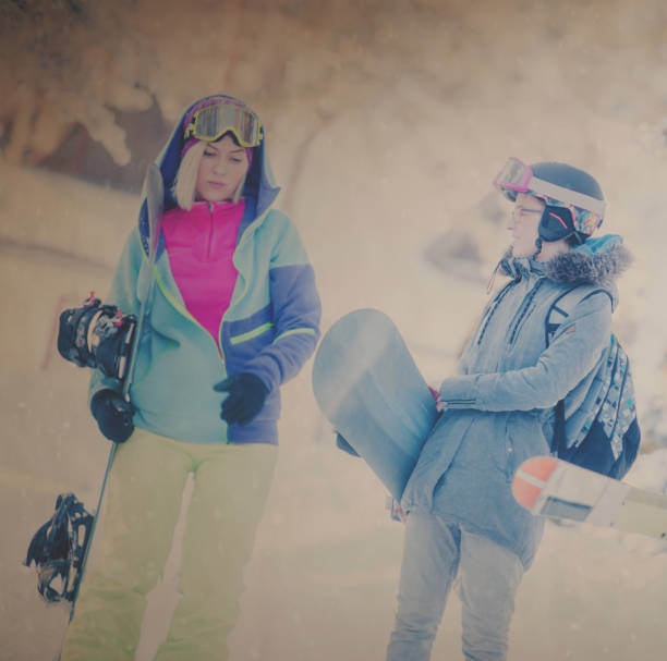 istock Two snowboarders on winter vacation 893603808