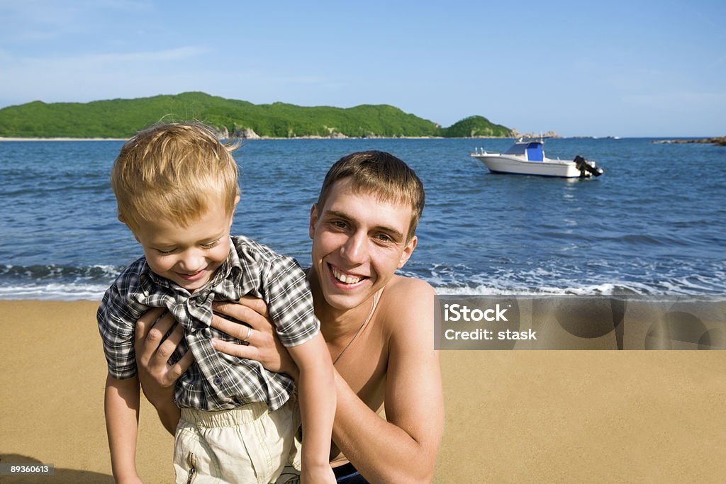 Uncle & nephew.beach.Island.Boat.  20-24 Years Stock Photo