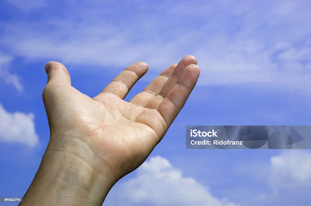 Open hand in the blue sky open hand in the blue sky, symbol of hope in the future A Helping Hand Stock Photo