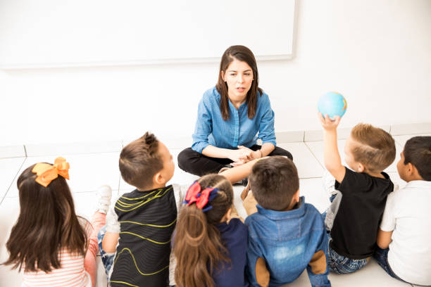 istock Preschool class sitting on the floor 893647918