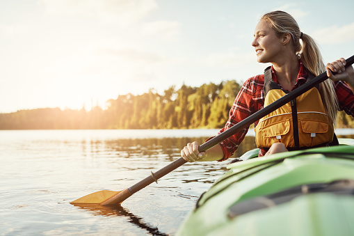 Shot of an attractive young woman out for canoe ride on the lake