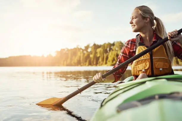 Shot of an attractive young woman out for canoe ride on the lake