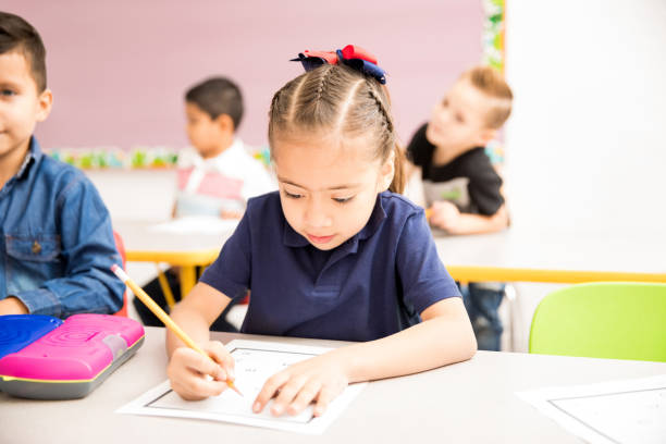 istock Cute preschooler working in a classroom 893652272
