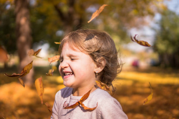 istock Happy kid running in park on sunny autumn day 893655838