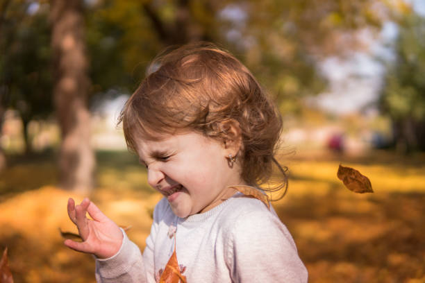 istock Happy kid running in park on sunny autumn day 893659092