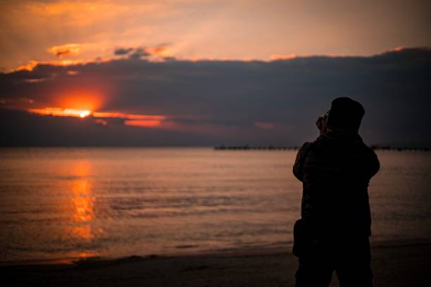 I took a picture of a man taking a photo of Okinawa sunset