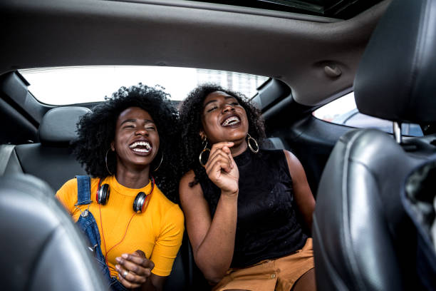 Afro girls having fun in the car