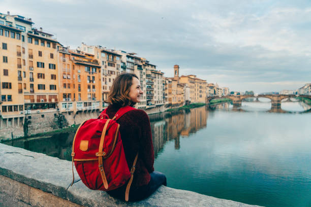 istock Woman sitting on Ponte Veccio and looking at view 893687626