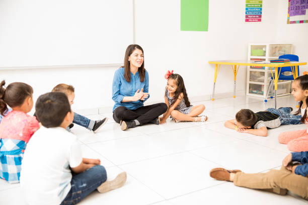 istock Preschool students and teacher having fun 893693292