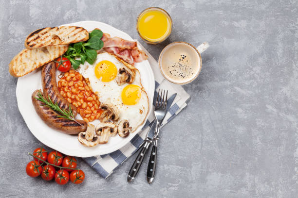 istock English breakfast. Fried eggs, sausages, bacon 893715110