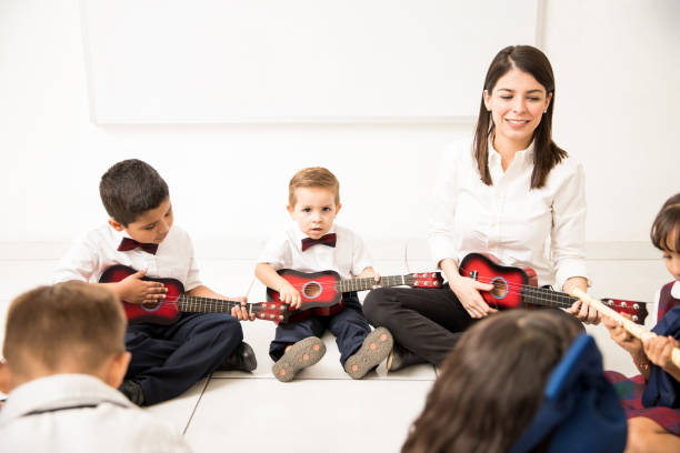istock Group of kids learning music in preschool 893716078