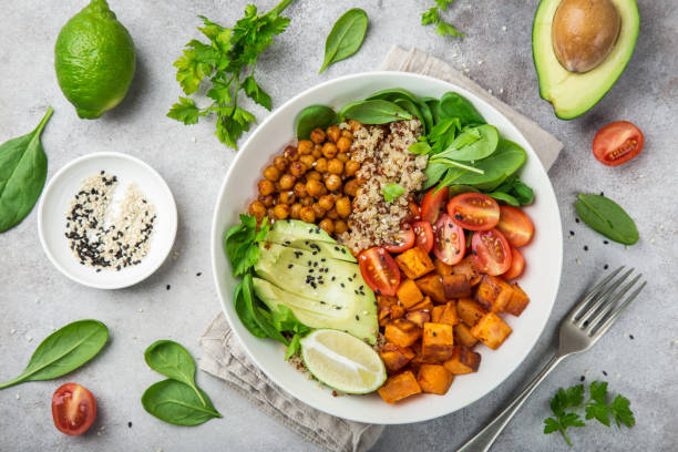 healhty vegan lunch bowl. Avocado, quinoa, sweet potato, tomato, spinach and chickpeas vegetables salad healhty vegan lunch bowl with ingredients. Avocado, quinoa, sweet potato, tomato, spinach and chickpeas vegetables salad. Top view Quinoa Salad with Roasted Veggies stock pictures, royalty-free photos & images