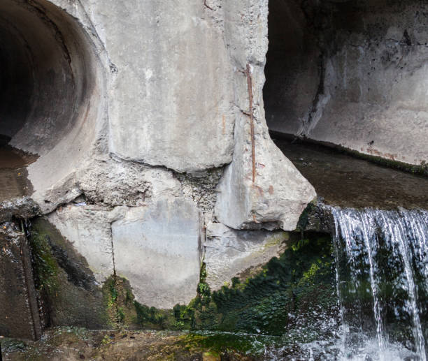 istock Run-off pipes discharging water 893729760
