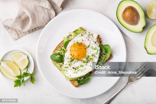 Toast With Avocado Spinach And Fried Egg Stock Photo - Download Image Now - Egg - Food, Toasted Bread, Breakfast