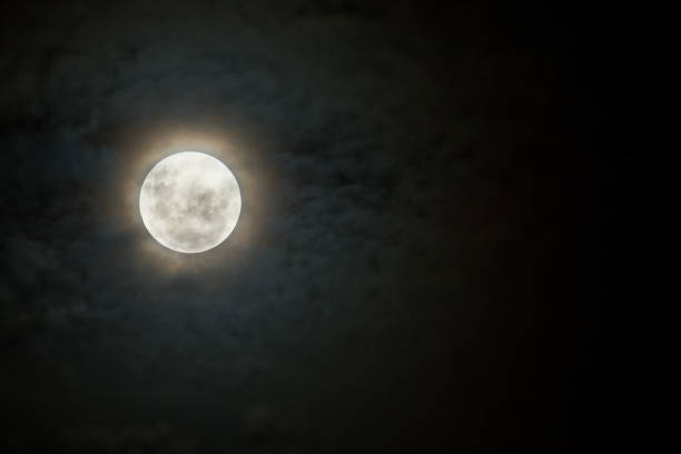 istock Scary moon on a dark and cloudy night with halo 893765276