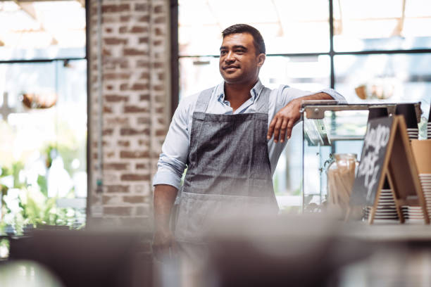 istock Employee - barista in modern cafe in Australia 893799850