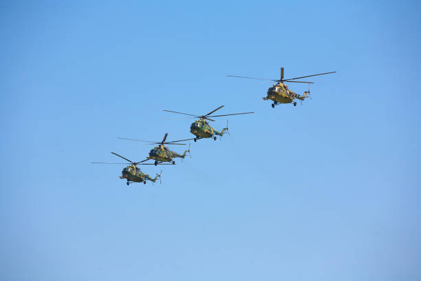 istock Four military helicopters against the blue sky. 893801648