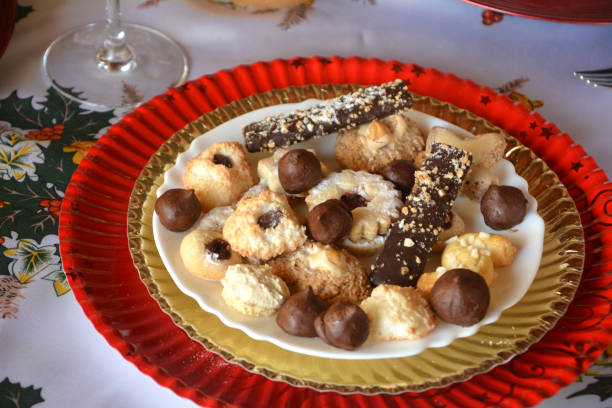 istock Christmas cookies with nuts, jam and coconut decorated on a plate on a table. 893805274