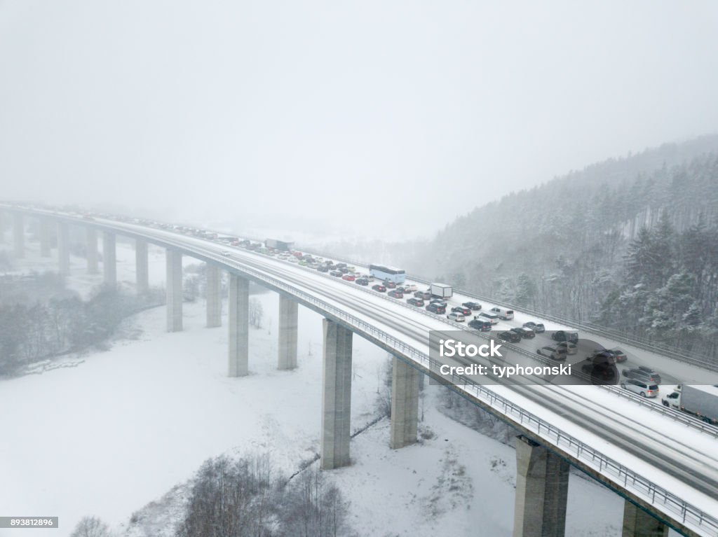 Highway bridge during a heavy snowfall Aerial view over a highway bridge during a heavy snowfall in winter Traffic Jam Stock Photo