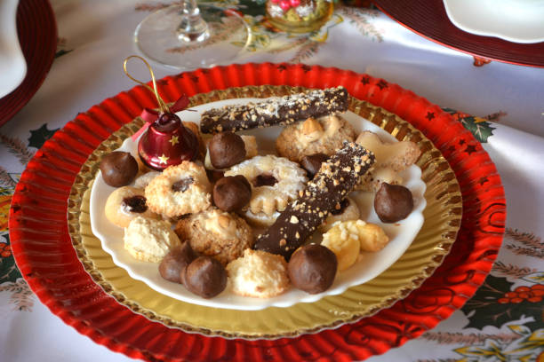 istock Christmas cookies with nuts, jam and coconut decorated on a plate on a table. 893817226