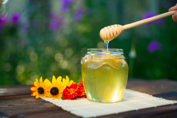 istock Delicious delicious honey in  jar on table 893836820