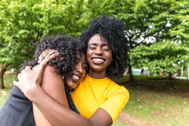 istock Afro friends hugging in the park 893894282