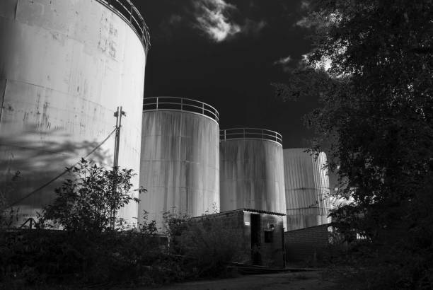 istock derelict industrial tanks overgrown with weeds and rusty 893899208