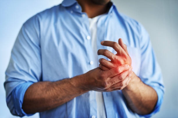 Pain in the hands can be symptoms of carpal tunnel syndrome Closeup shot of an unidentifiable businessman suffering with pain in his hands carpal tunnel syndrome photos stock pictures, royalty-free photos & images