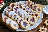 Traditional Linzer Christmas cookies filled with strawberry jam and dusted with sugar