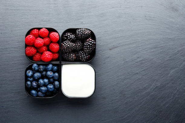 istock Raspberries blueberries blackberries with Greek yogurt 893949170