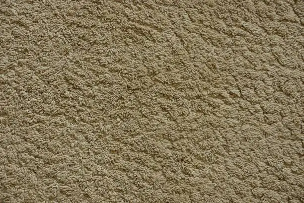 Photo of gray texture of a piece of wool carpet fabric