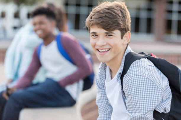 istock Handsome male high school student waits for school to start 893988504