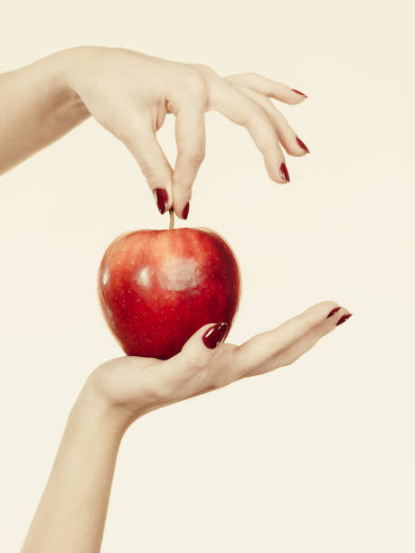 istock Woman hand holding delicious red apple 894004430