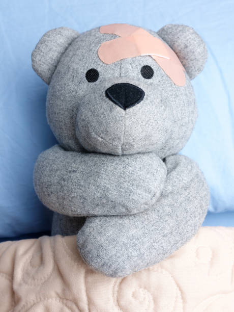 istock Injured Teddy Bear plasters bed hugging 894018310