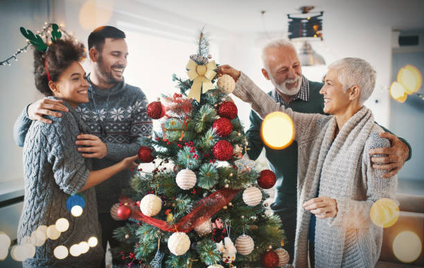 Family decorating a Christmas tree.