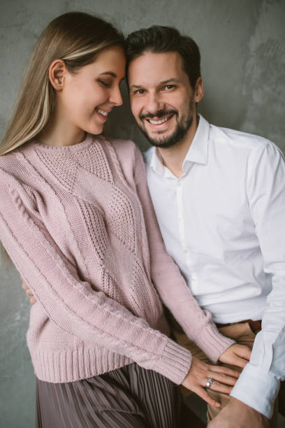 istock Young happy beautiful couple in loft smiling 894020878