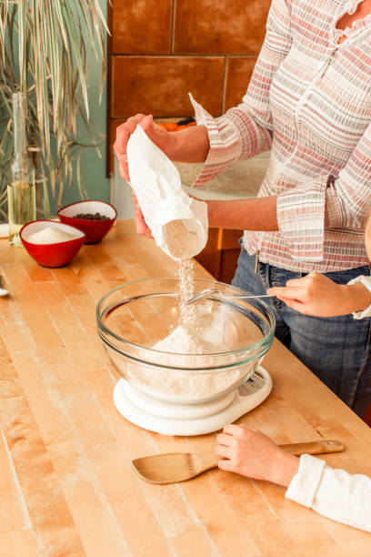 istock Mother and Daughter Preparing Ingredients for Making Cookies Together 894037236