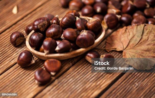 Ripe Chestnuts In A Frying Pan On Old Wooden Table Close Up With Copy Space Roasted Chestnuts For Christmasn Stock Photo - Download Image Now