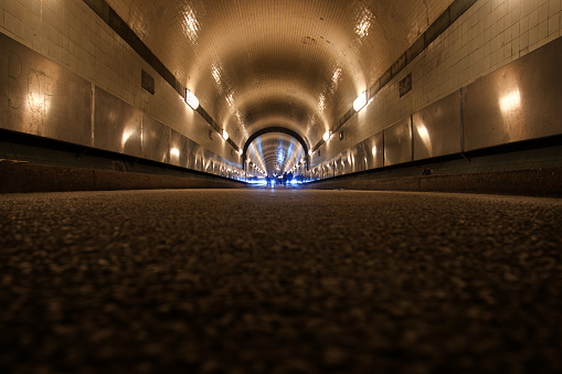 Hamburg, Germany - 12/10/2017: Inside the old Elbe tunnel from 1911. The tunnel connects the district Sankt Pauli with the docks on the opposite side of the river Elbe and is still used by vehicles and pedestrians.
