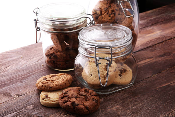 istock Chocolate cookies in a glass jar on white background 894056040