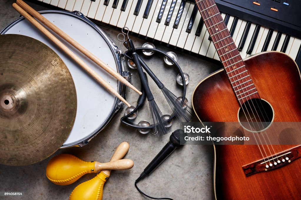 musical instruments a group of musical instruments including a guitar, drum, keyboard, tambourine. Musical Instrument Stock Photo