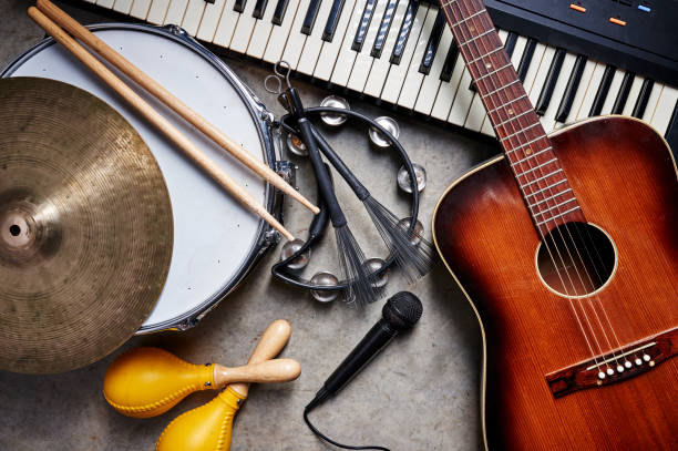musical instruments a group of musical instruments including a guitar, drum, keyboard, tambourine. acoustic guitar photos stock pictures, royalty-free photos & images