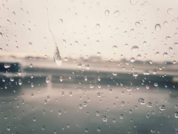 istock An airport on a rainy day, as shot through a plane window. 894058340