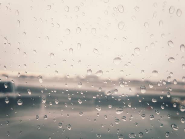 istock An airport on a rainy day, as shot through a plane window. 894058342