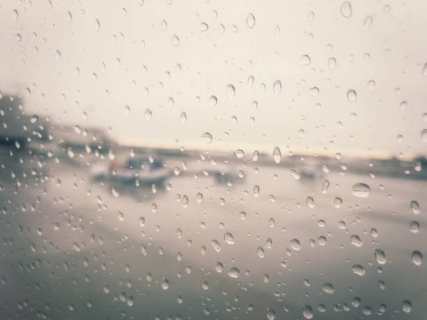 istock An airport on a rainy day, as shot through a plane window. 894058354