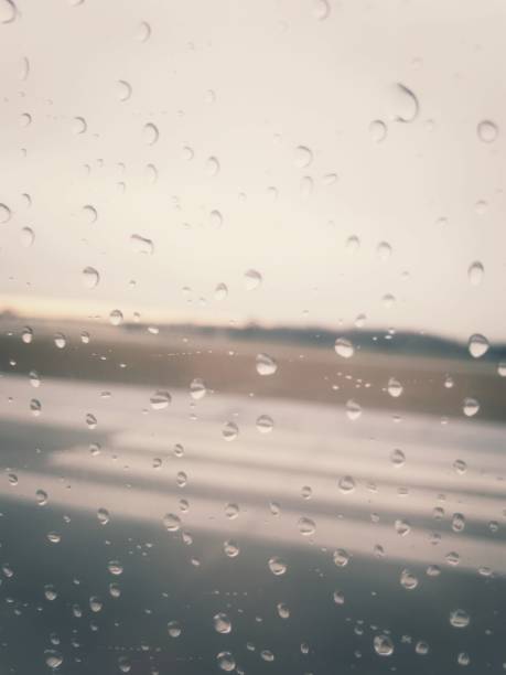 istock An airport on a rainy day, as shot through a plane window. 894058388