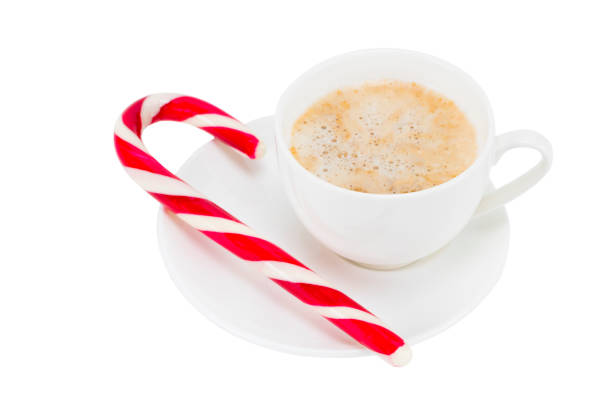 istock white cup of coffee with candy the Christmas cane isolated on white background 894061380