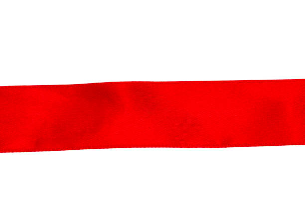 istock The red silk ribbon is evenly stretched on the white surface 894061424